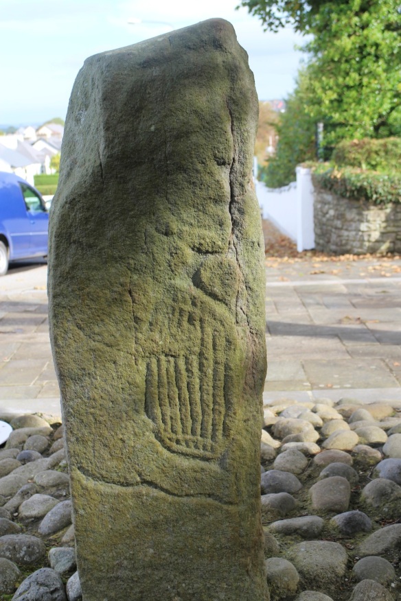 Here’s David holding the harp, closer. It was an imprecise art, trying to find a suitable stone. This pillar has, perhaps, three sides, with a fourth side too small to draw on.